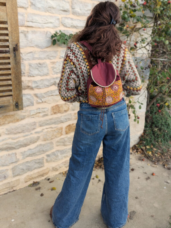 Sac Évolution Nomade porté en version sac à dos, modèle en extérieur, patron sac bandoulière transformable.